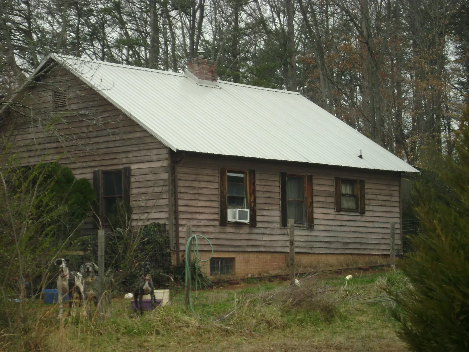 White metal roof on an old wood sided farmhouse, from a Metal Roof Installation job in Terryville